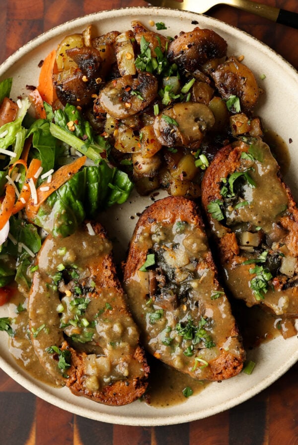 sun dried tomato roast on a plate with salad and mushrooms