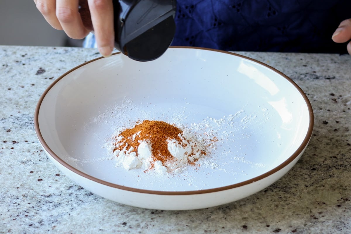 adding cornstarch and spices to the bowl
