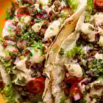 close-up of chipotle whipped tofu, roasted zucchini, and crispy lentils tacos