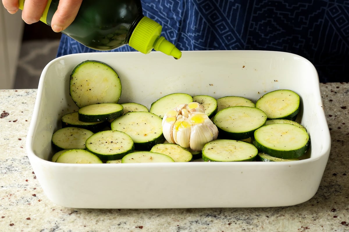 adding garlic and olive oil to the pan