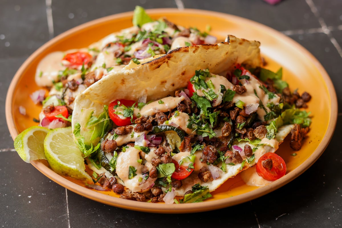 tacos made with chipotle whipped tofu, roasted zucchini, and crispy lentils