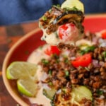 taking a bite of chipotle whipped tofu bowls