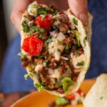 hand holding a taco made from the whipped tofu, zucchini, and lentils