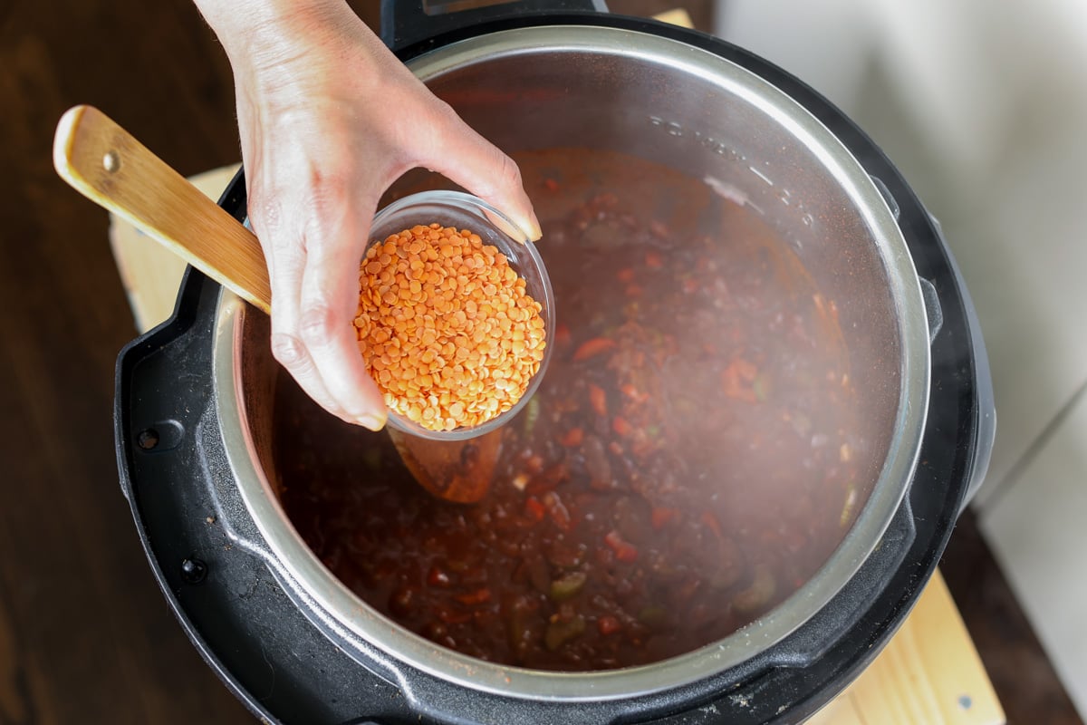 adding red lentils to the Instant Pot