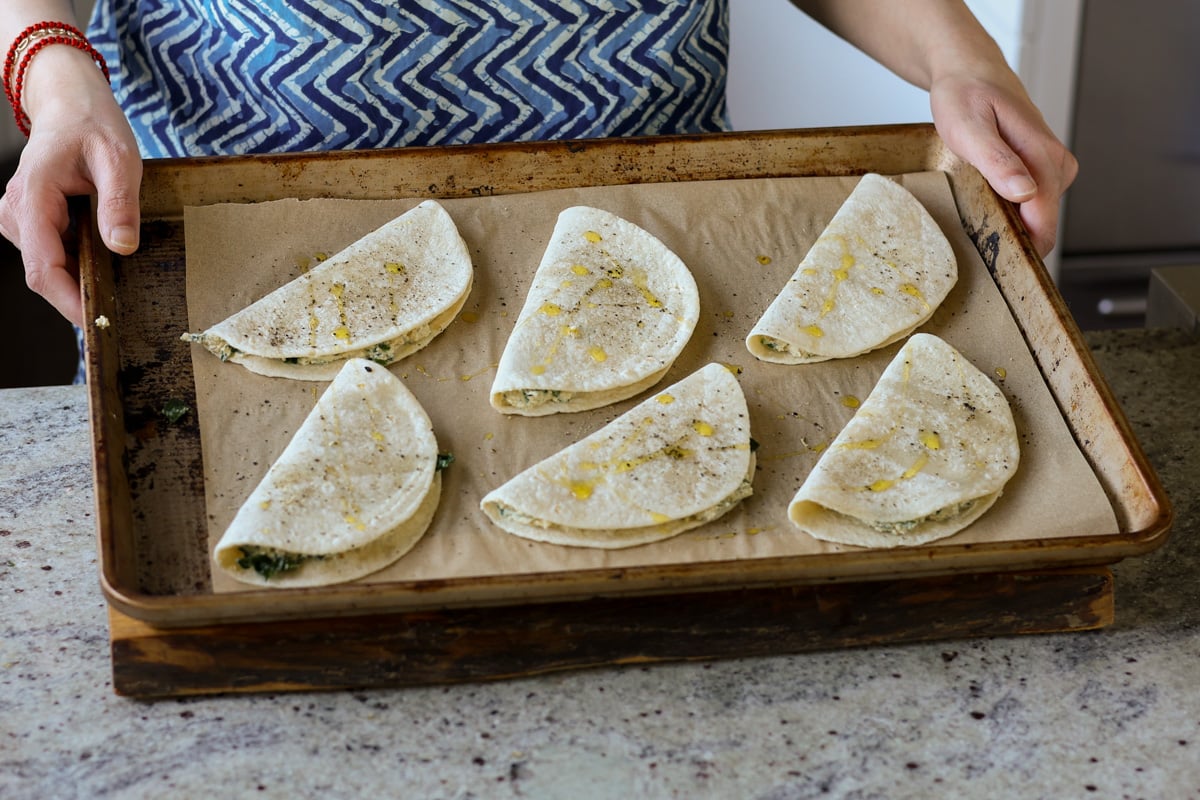 ricotta tacos on the baking pan, ready to bake