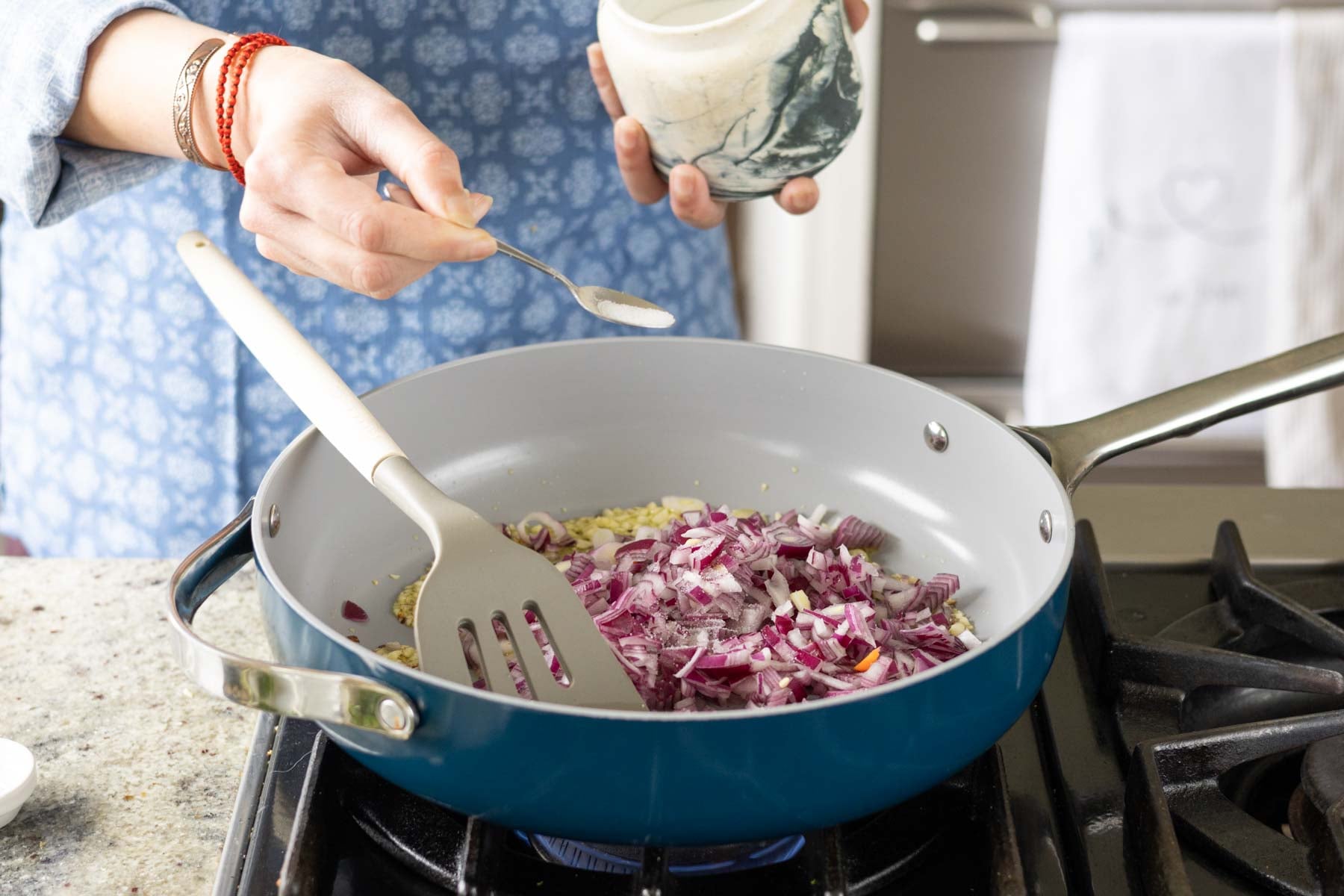 adding onion and salt to the pan