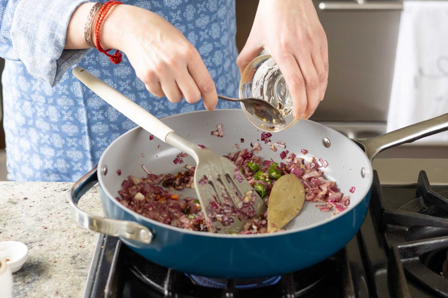 adding green chili to the pan
