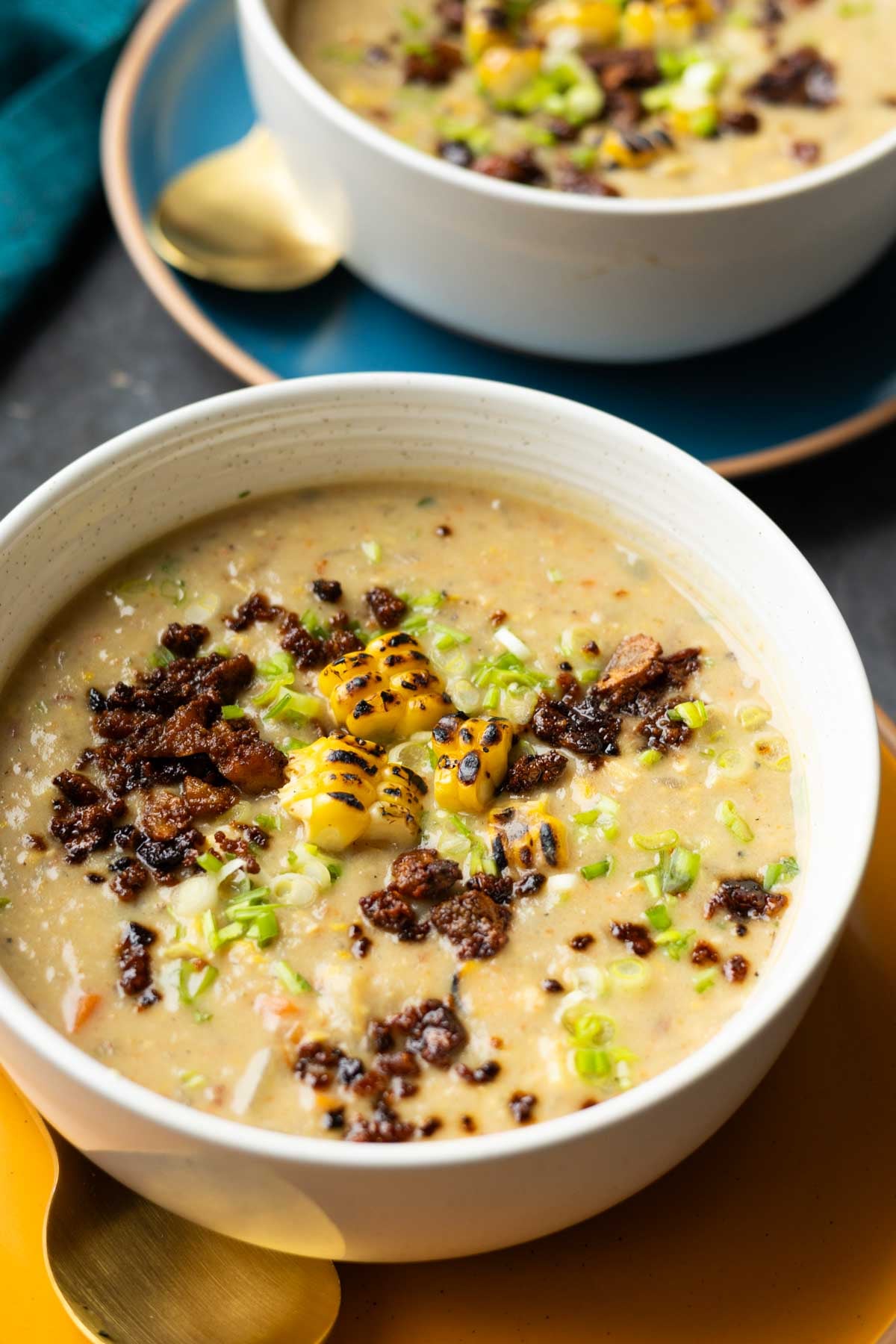close-up of corn chowder in bowls with all the toppings