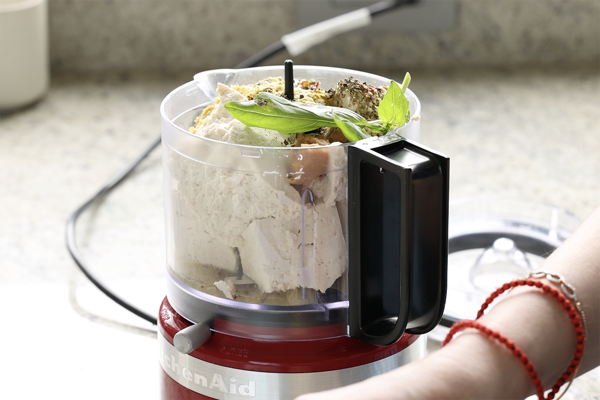 adding tofu ricotta ingredients to the food processor