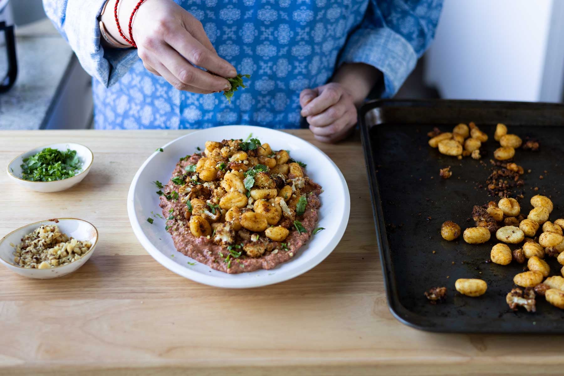 adding fresh herbs to the plate