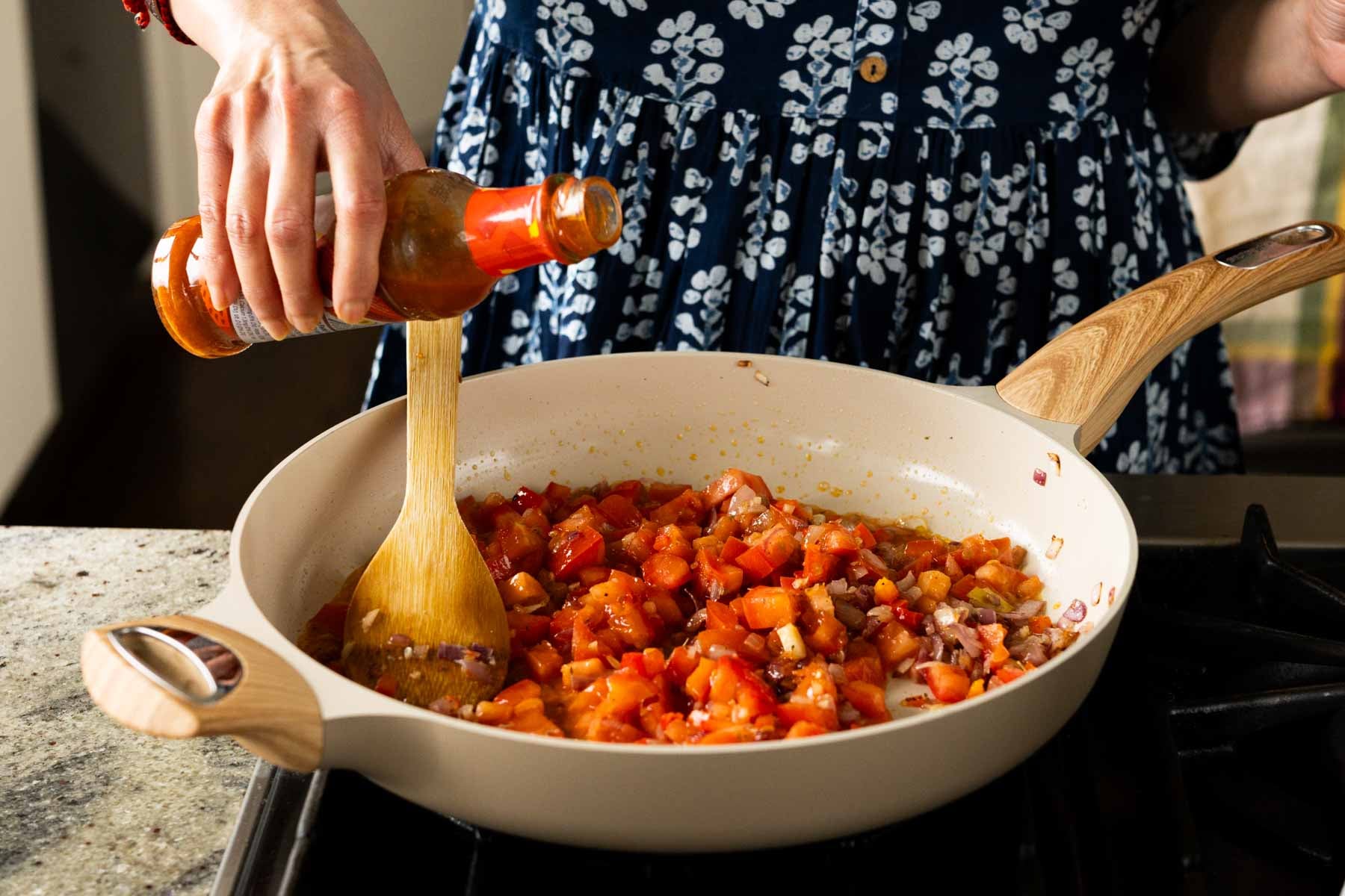 adding peri-peri sauce to the pan
