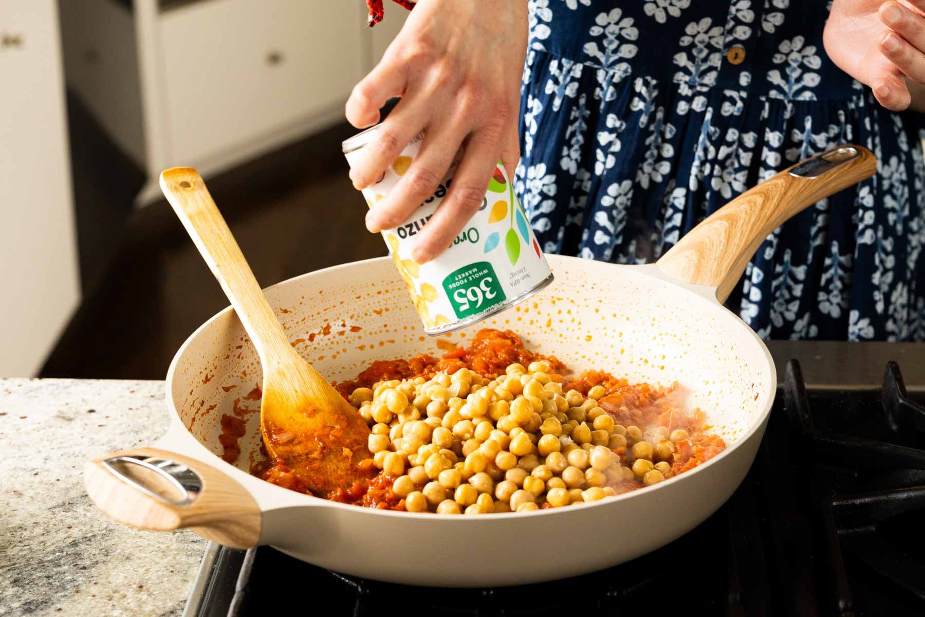 adding chickpeas to the pan