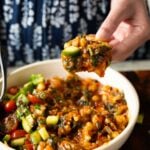 scooping up some of the peri-peri chickpeas from a bowl