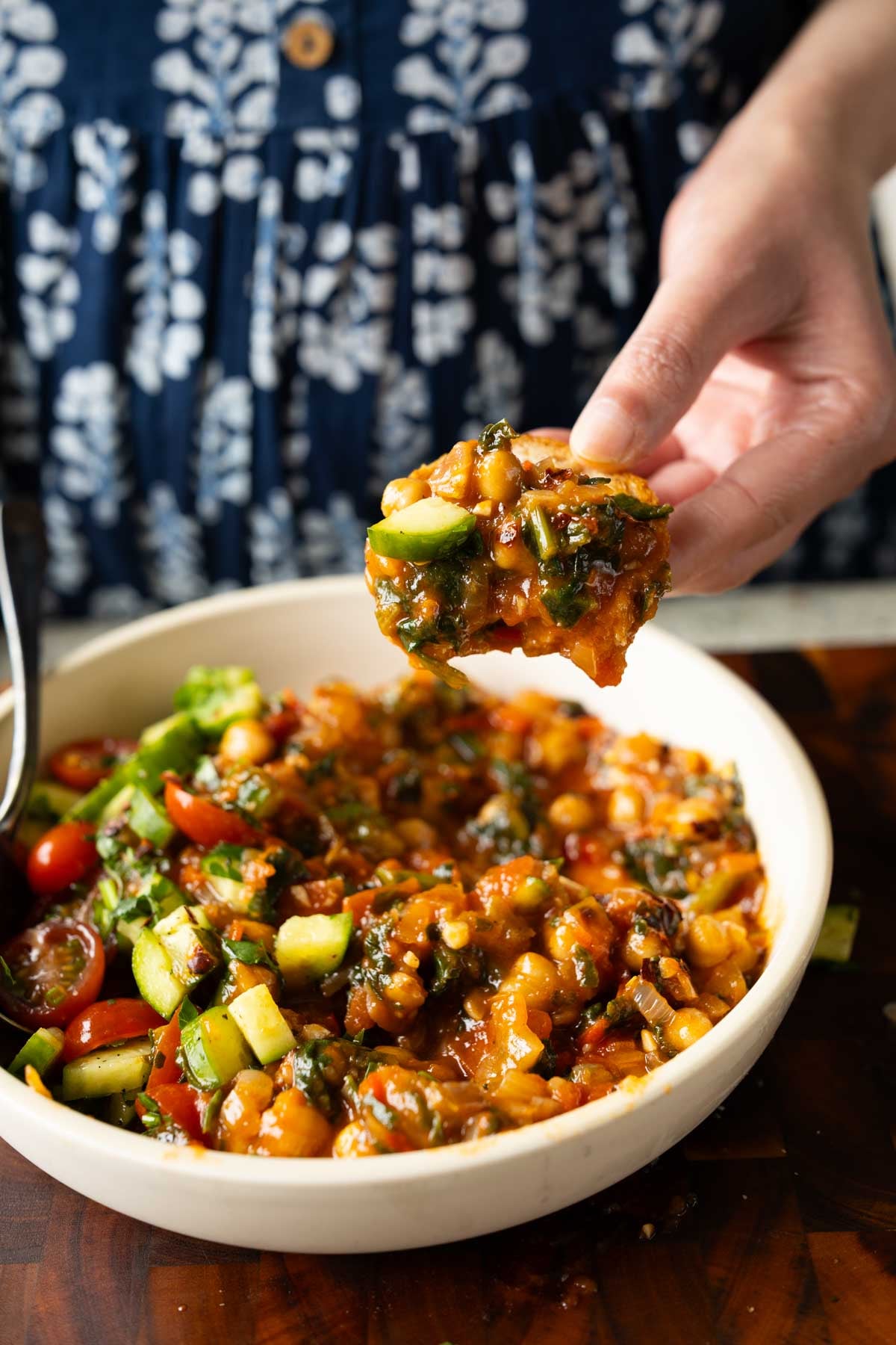 scooping up some of the peri-peri chickpeas from a bowl