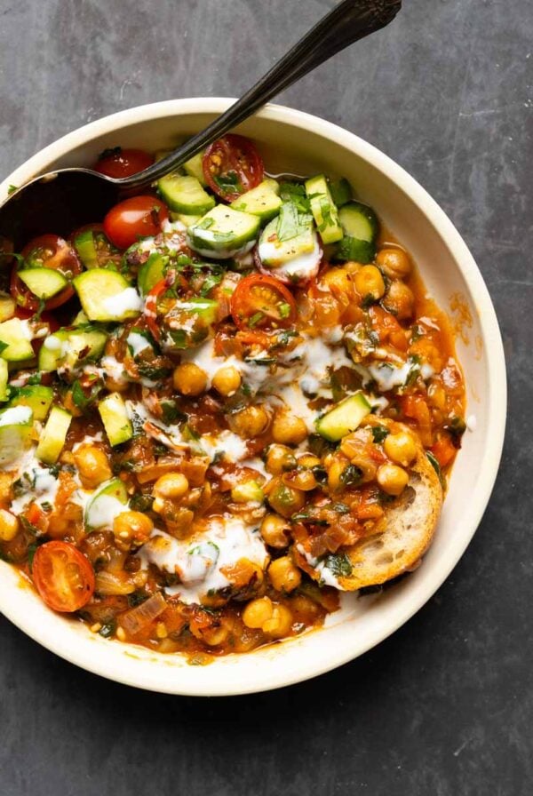 bowl of peri-peri chickpeas topped with the salsa and other garnishes