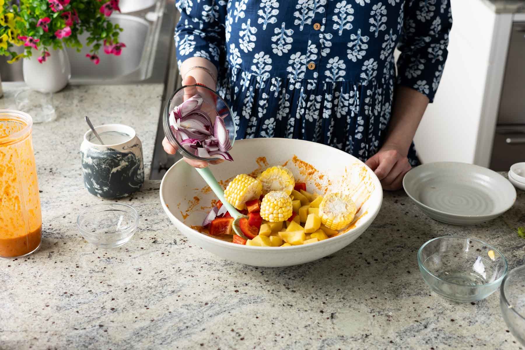 adding the sliced veggies to a bowl