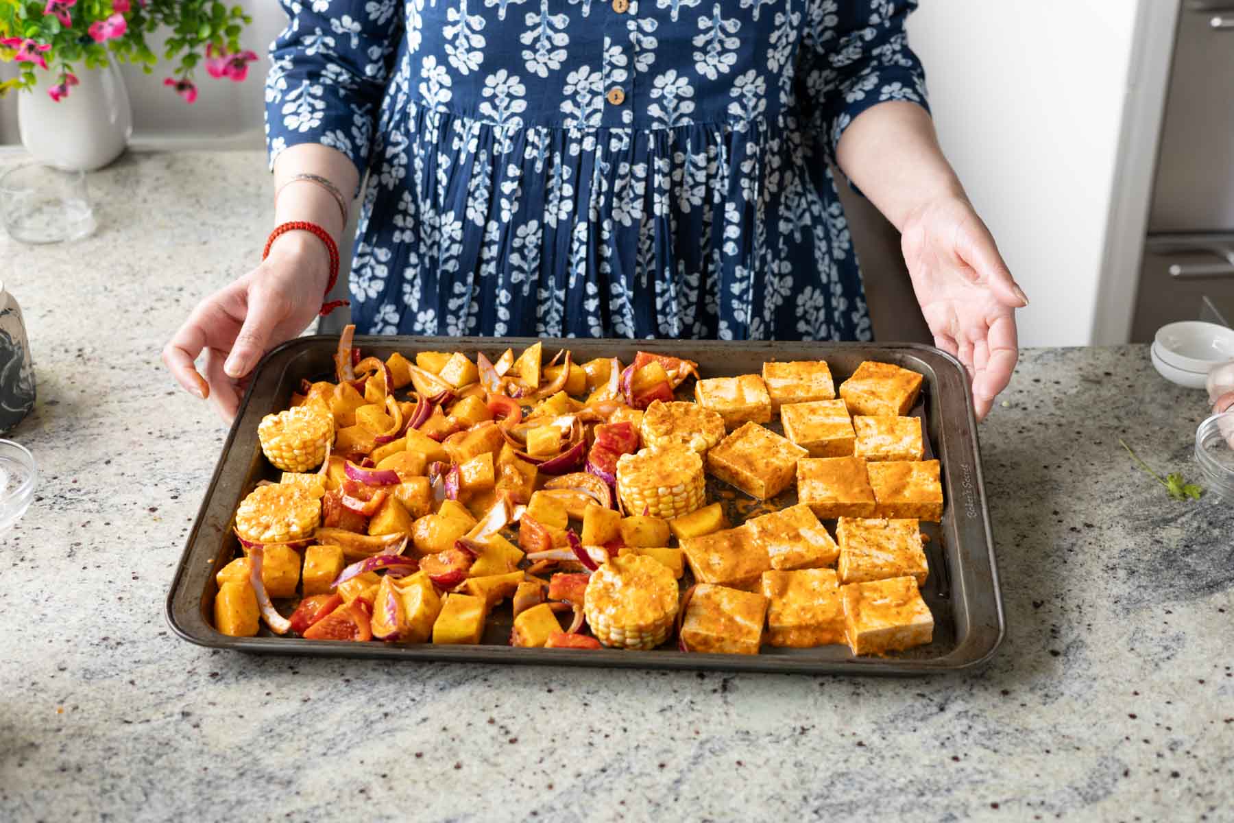 peri-peri tofu and vegetables on the sheet pan before baking