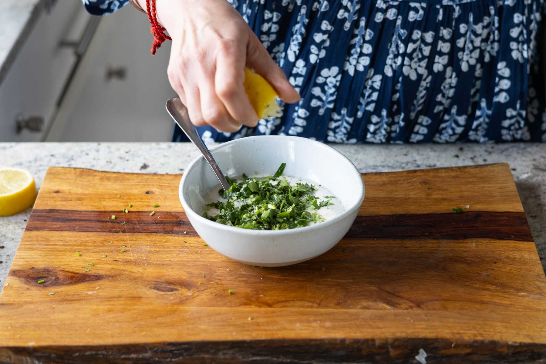 adding the yogurt sauce ingredients to a bowl