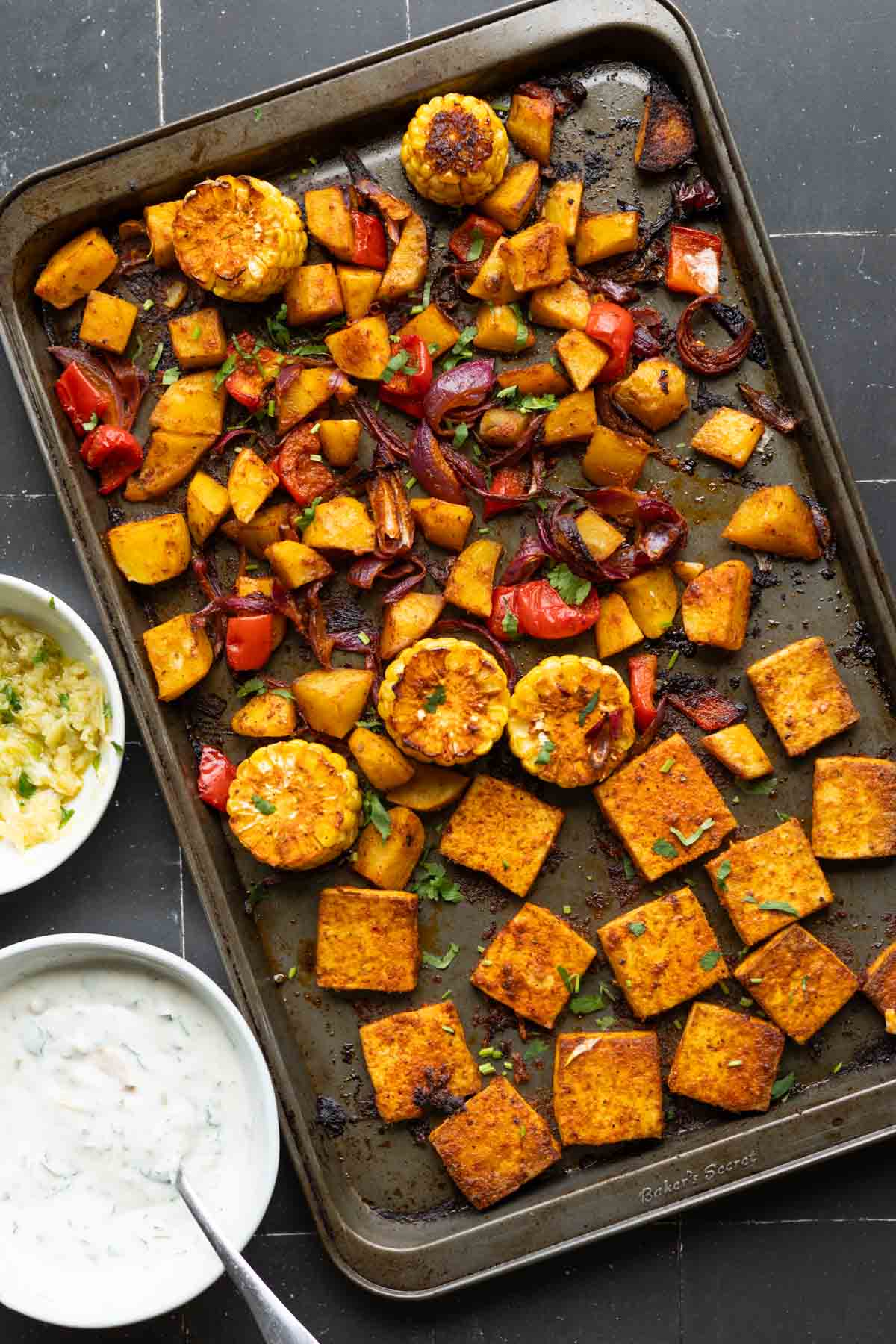 peri-peri tofu and vegetables on the sheet pan after baking
