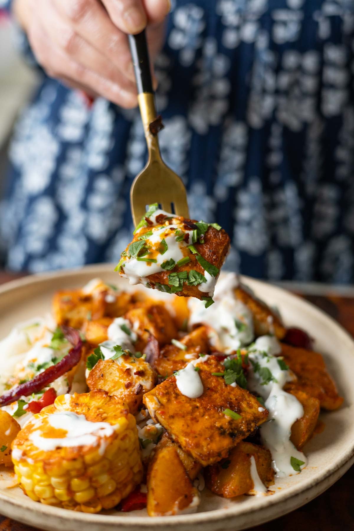 close-up of fork taking a bite of peri-peri tofu and vegetables