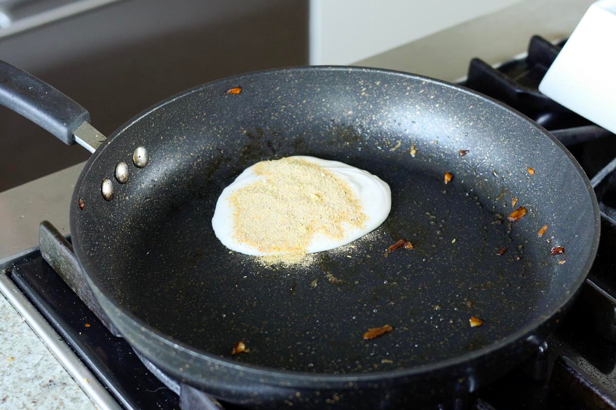 adding the scramble mixture to the skillet