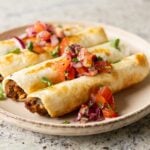 chickpea mushroom taquitos on a plate with pico de gallo