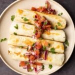 chickpea mushroom taquitos on a plate with pico de gallo