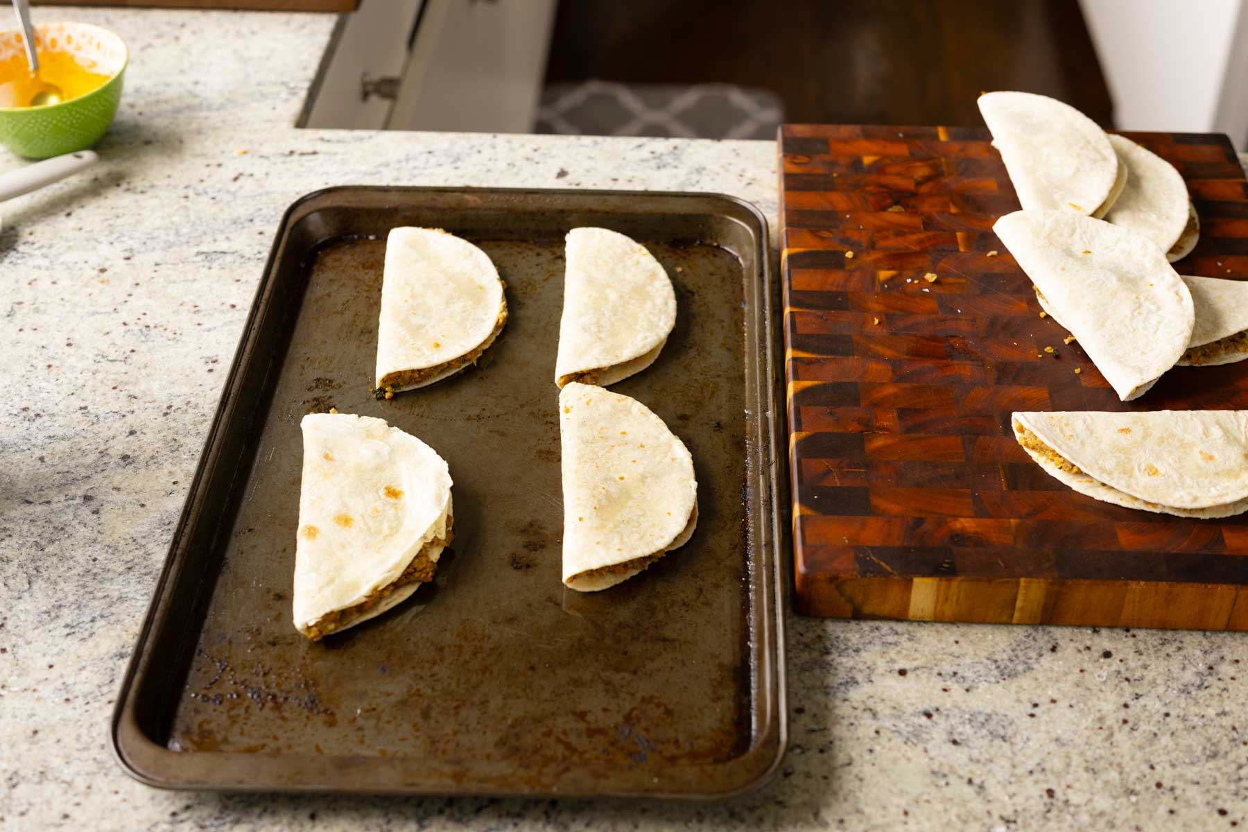 paratha tacos on the baking sheet before baking