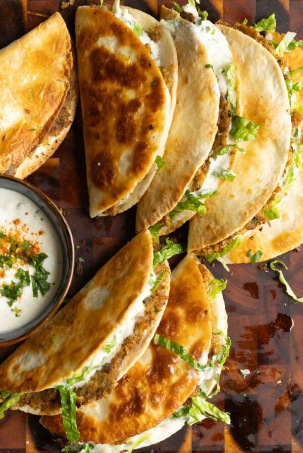 paratha tacos on a serving platter with raita