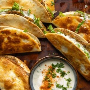 paratha tacos on a serving platter with raita