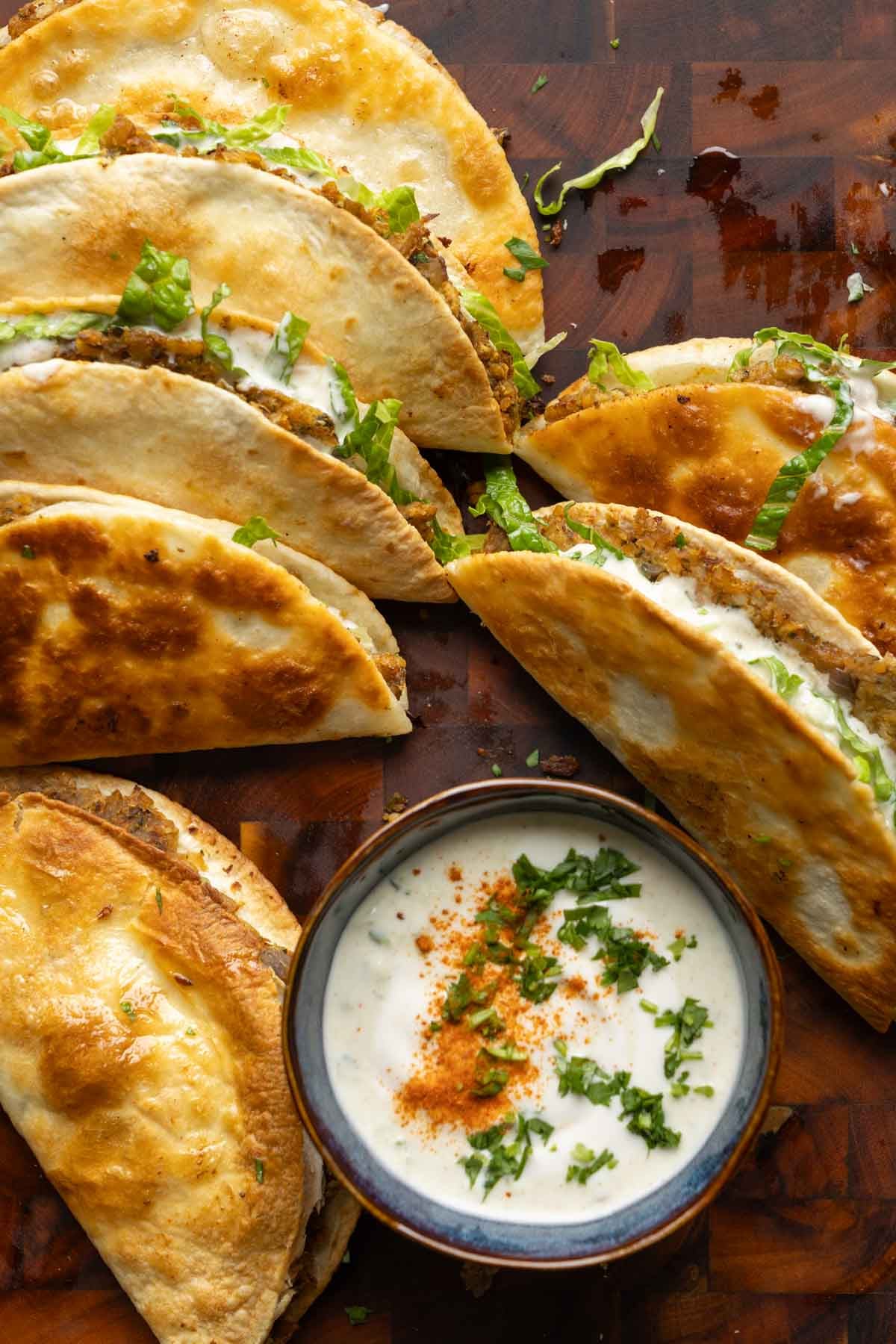 paratha tacos on a serving platter with raita