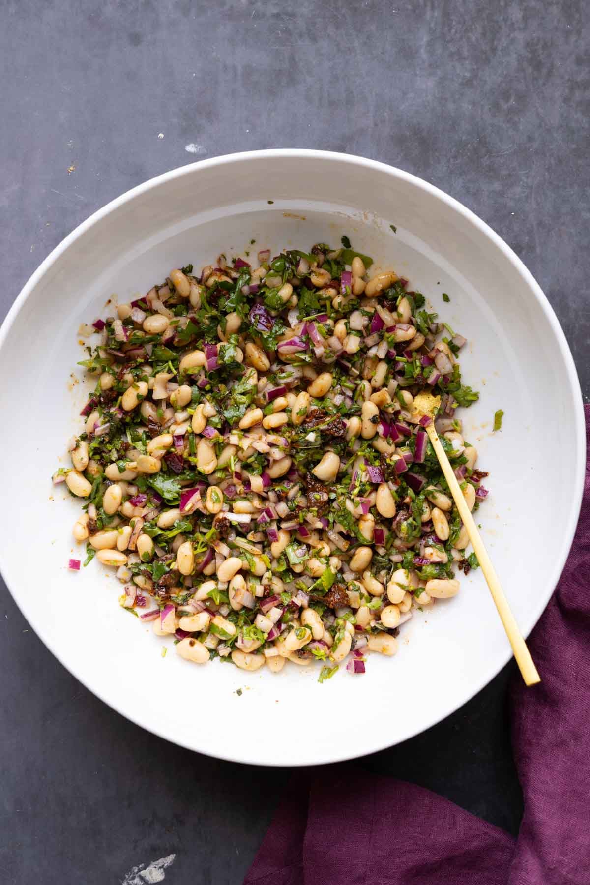 white bean salad after mixing with the dressing