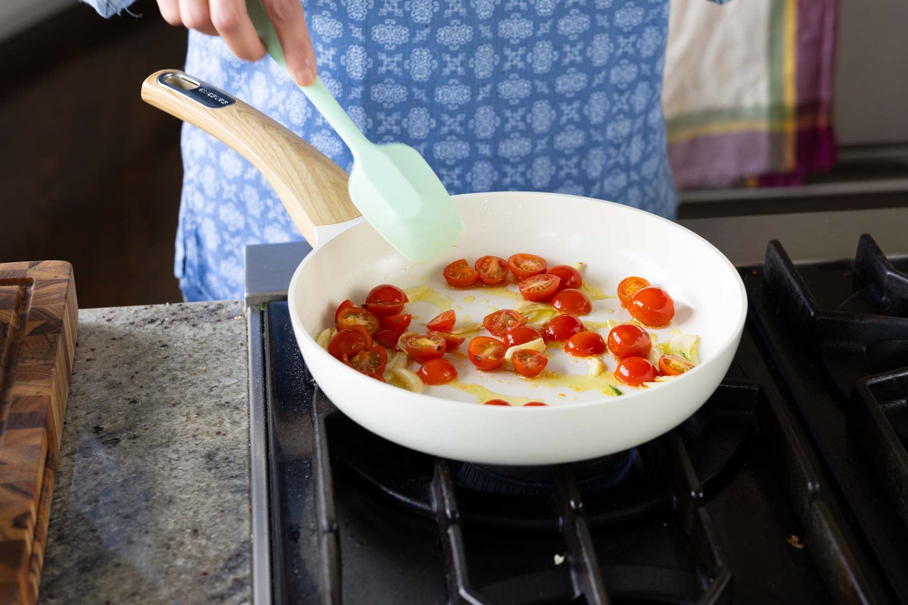 adding cherry tomato to the pan
