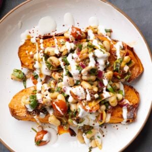 marinated white bean salad over sweet potatoes with creamy sauce on top