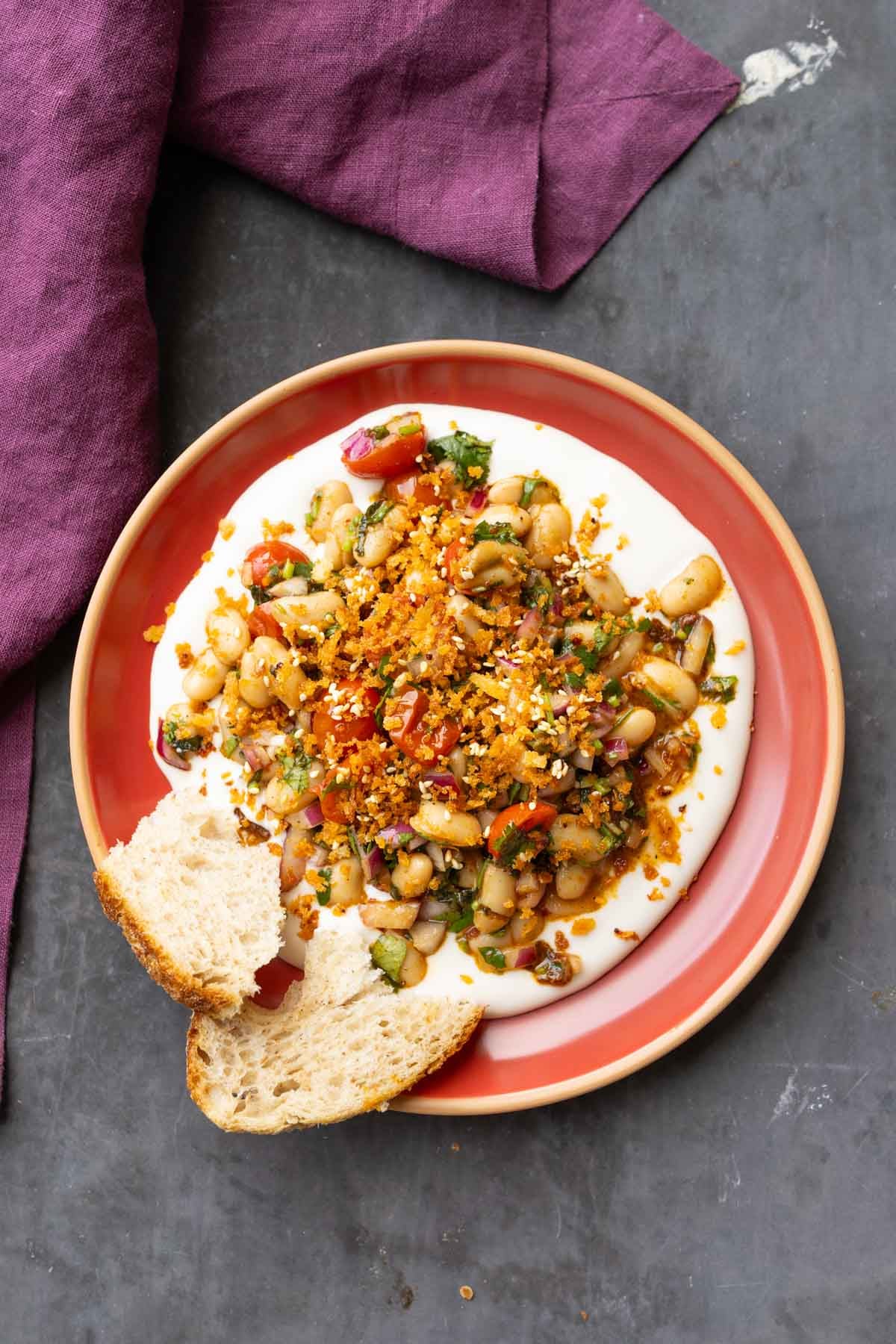marinated white bean salad served over hummus with bread