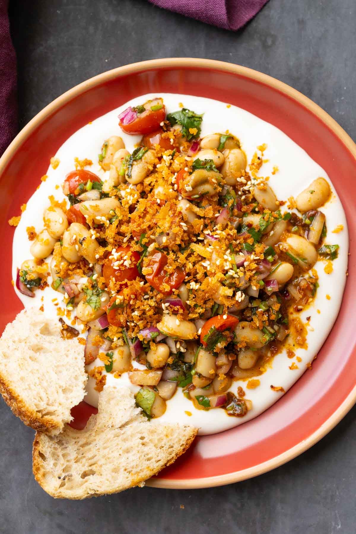 marinated white bean salad served over hummus with bread