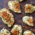 Indian chilli cheese toasts on a cutting board with some sliced in half