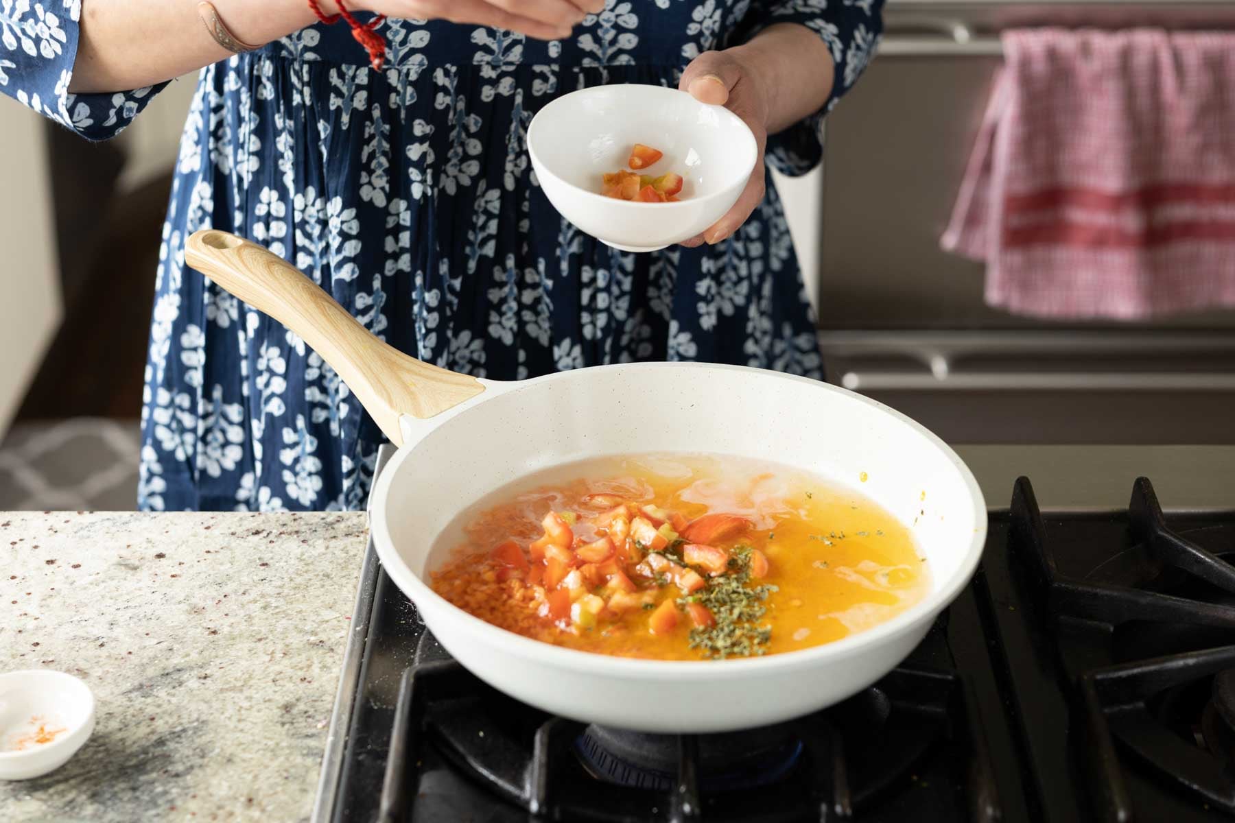adding the remaining dal ingredients to the pan