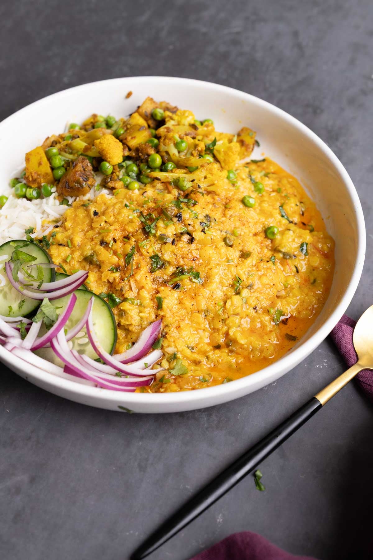 plate of jeera dal with a side of cauliflower and potatoes