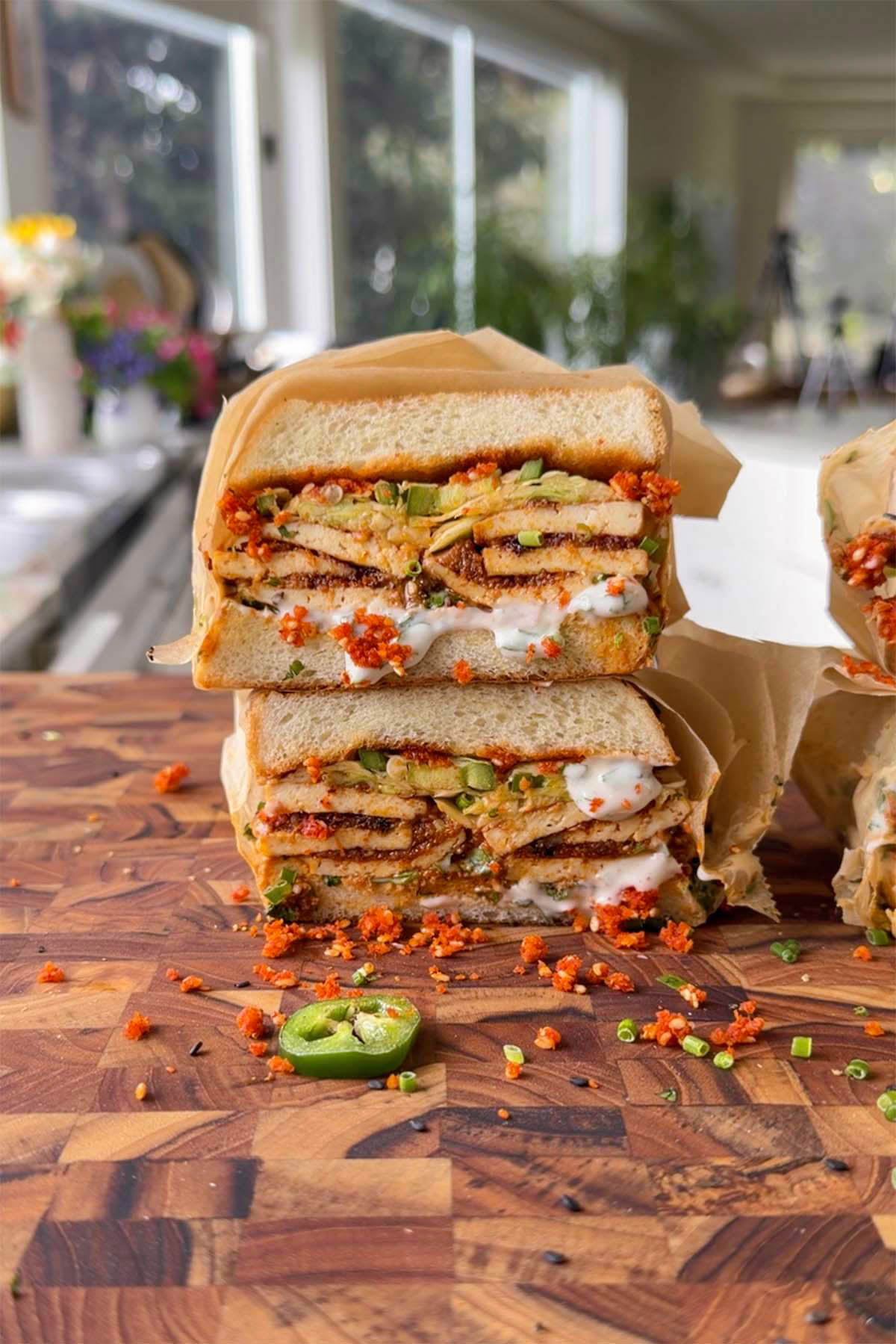 stack of coconut tofu sandwiches on a cutting board