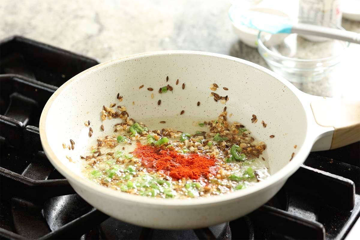 adding kashmiri chili powder to the tadka