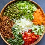 gochujang salad ingredients in a bowl before mixing