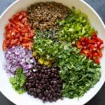 dense bean salad ingredients in the bowl before adding the dressing
