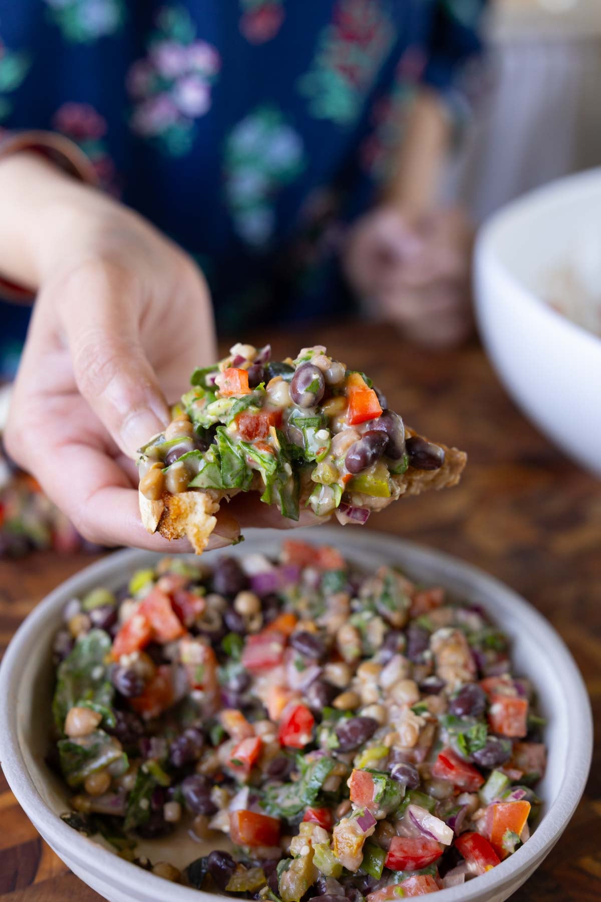 toasted bread scooping up some dense bean salad