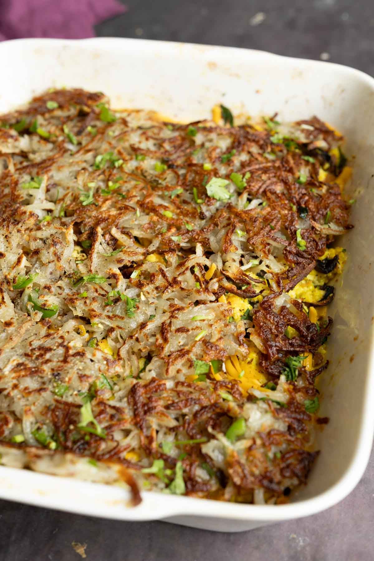 hashbrown casserole in the pan after adding the hashbrowns on top