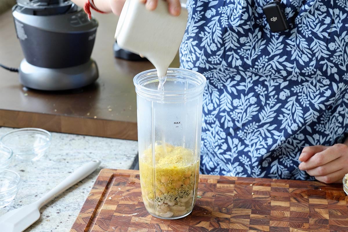 adding cream sauce ingredients to the blender