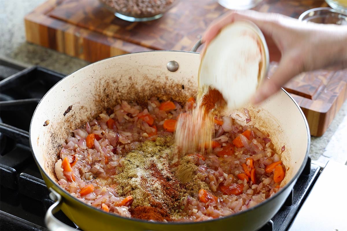 adding spices to the pan