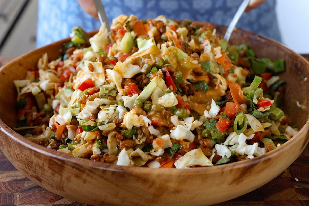 tossing the peanut crunch gochujang salad