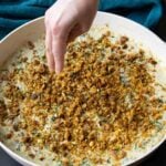 adding the chickpea crumble to the pepper beans