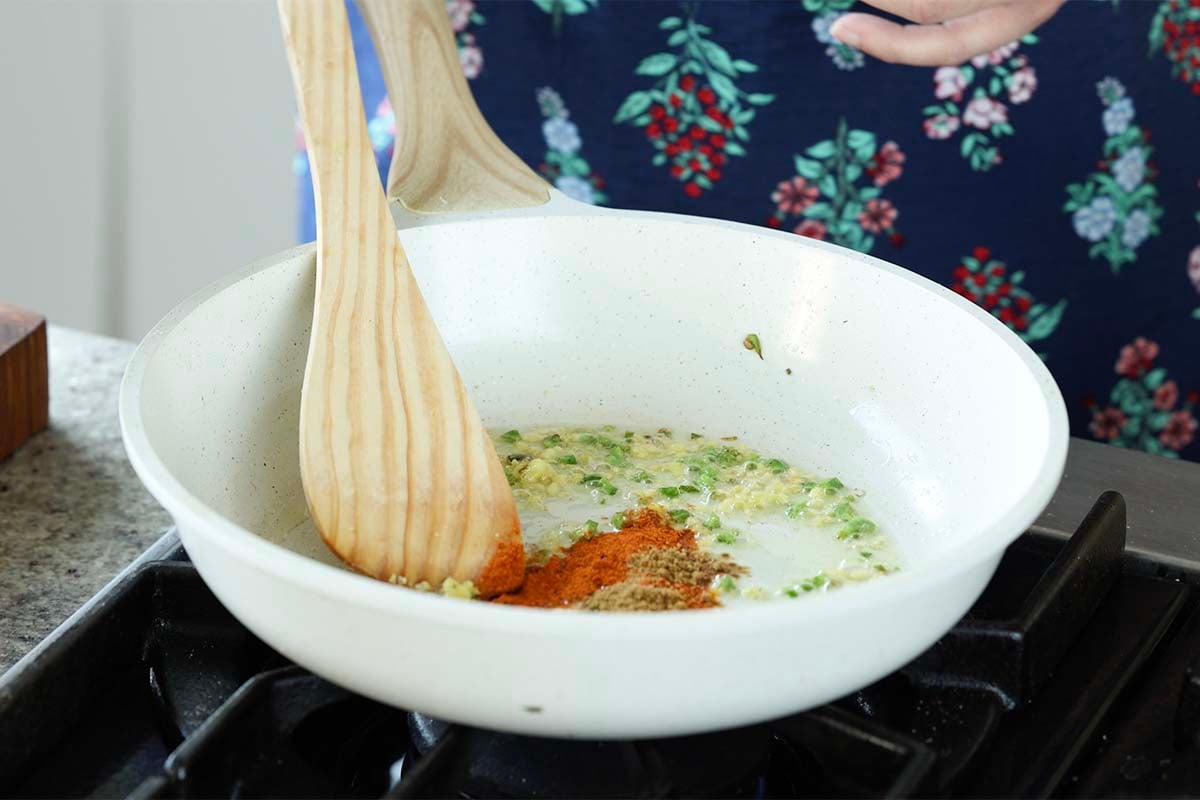 adding ground spices to the pan